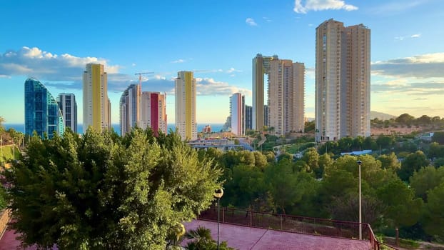 A breathtaking view of modern skyscrapers with an ocean backdrop, showcasing vibrant architecture that captivates