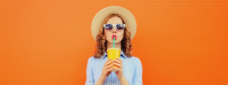 Summer vacation, tourism, beautiful young woman drinking fresh juice, stylish girl in tourist straw hat with cup of coffee on orange background