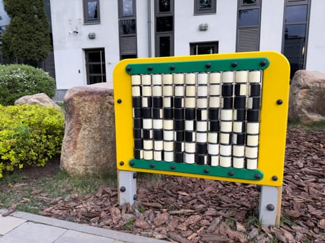 Educational play panel with rotating cubes in park setting. Designed to support cognitive development, coordination, and pattern recognition in young children through interactive learning