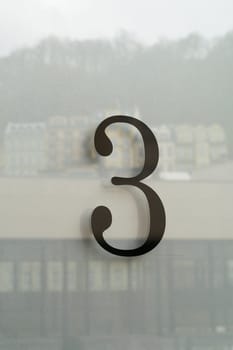the house number 3 three on the glass of the front door of a house
