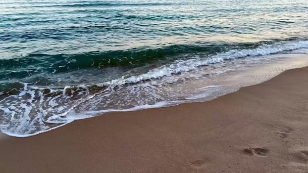 A captivating beach scene unfolds with gentle waves gradually washing ashore at enchanting twilight hours
