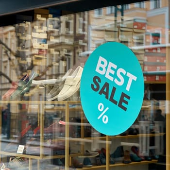 Sticker on the window of a shoe store with the inscription Best Sale