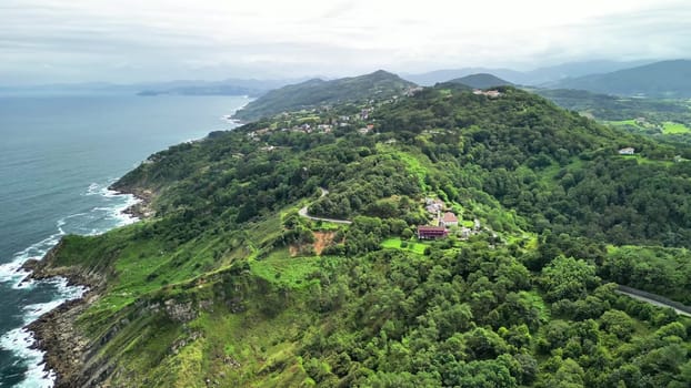 An aerial view capturing the stunning beauty of a coastal region adorned with lush greenery and peaceful ocean waves