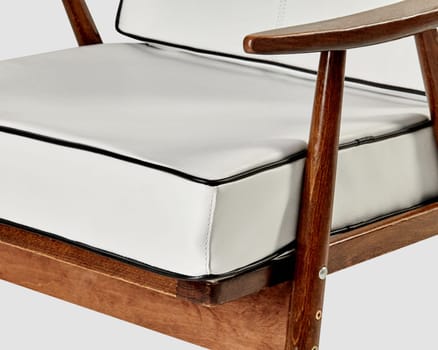 Modern white leather armchair with wooden frame displaying comfortable elegance