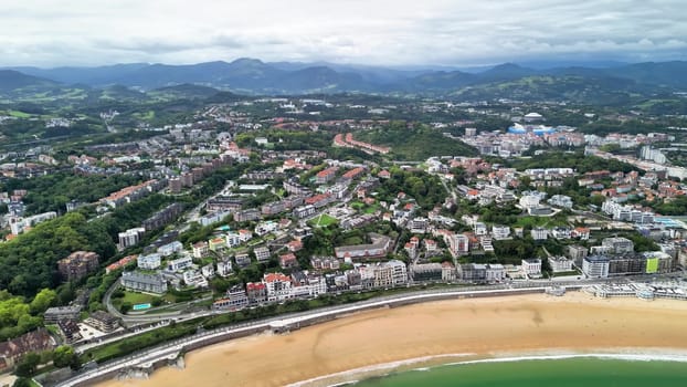 Breathtaking aerial footage highlights the beauty of a coastal citys beach along with its lush, surrounding mountains