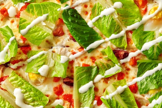 Close-up of appetizing caesar salad pizza featuring fresh romaine lettuce, creamy dressing, chicken, and parmesan cheese, offering a unique and flavorful twist on traditional pizza