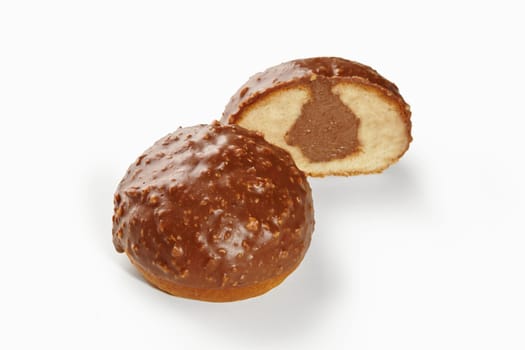 Two small chocolate hazelnut cakes, one cut open revealing a soft inside with chocolate filling
