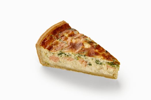 Delicious quiche slice with salmon, spinach, and a creamy filling, creating a tempting culinary delight