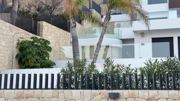 A beautiful luxury villa with modern architecture, surrounded by lush greenery and stunning coastal views