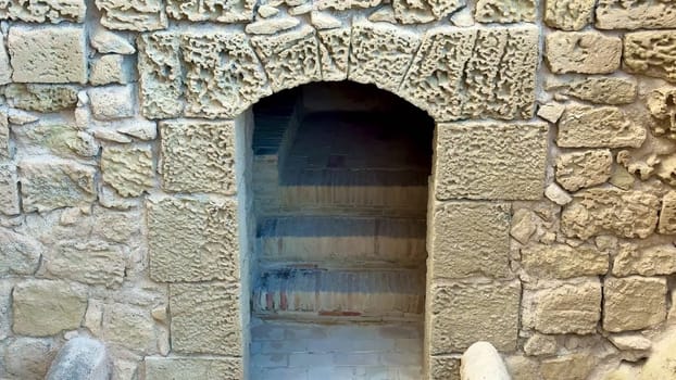 Explore this stunning ancient stone archway leading to stairs, showcasing historic architectural design.