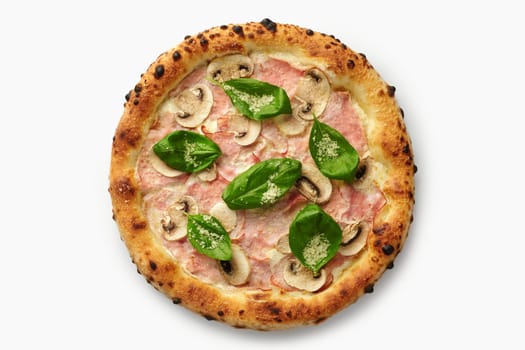 Top view of a whole pizza showing ham, mushrooms, basil leaves and grated cheese on a white background