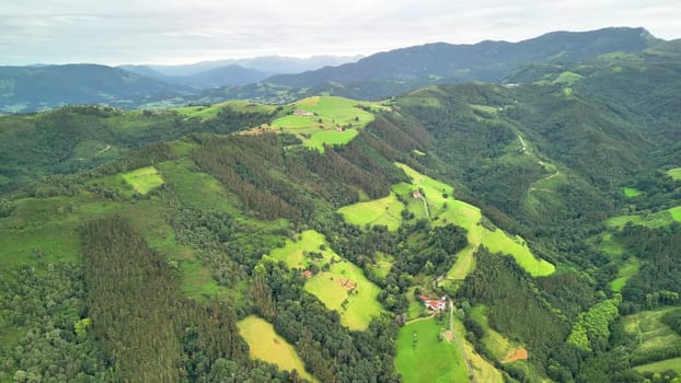 Stunning aerial view beautifully capturing vibrant green hills along with serene valleys in a breathtaking landscape