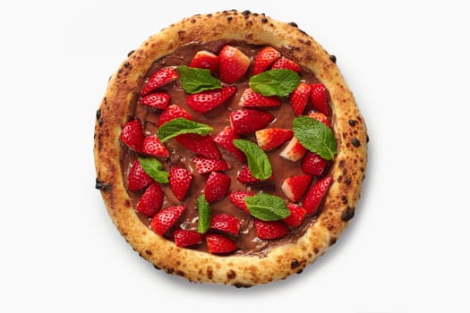 Sweet pizza with chocolate cream, fresh strawberries and mint on a white background