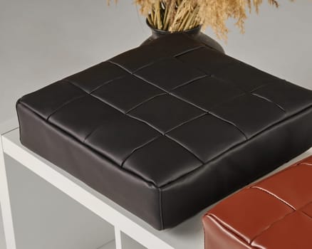 Stylish black leather seat cushion adds a touch of elegance to a contemporary interior design setting