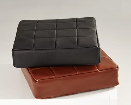 Comfortable padded leather cushions in black and brown, adding a touch of modern design to interior decor
