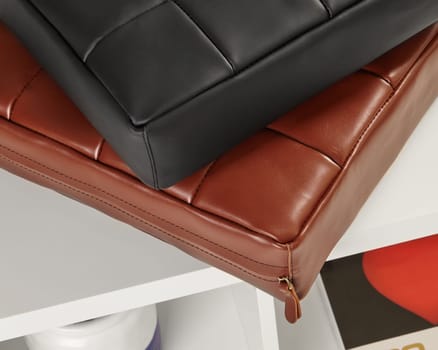 Brown and black leather cushions add a touch of elegance to a contemporary interior setting