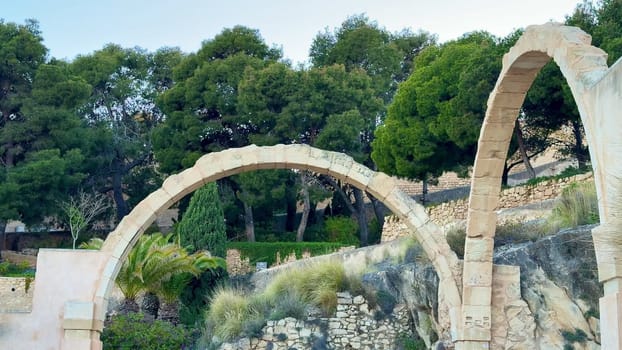 The beautiful stone arches, framed by vibrant and lively trees, create a truly serene and calming landscape