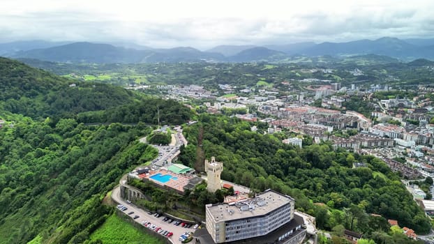 Experience a breathtaking aerial view of a vibrant landscape featuring a beautiful pool and urban scenery