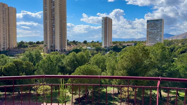 A stunningly beautiful landscape view showcasing lush greenery alongside modern architecture beneath a bright blue sky