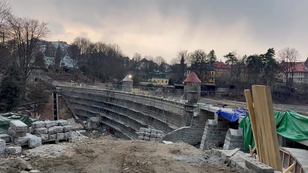 An active urban construction site displaying stone structures and a variety of materials for a new developing project