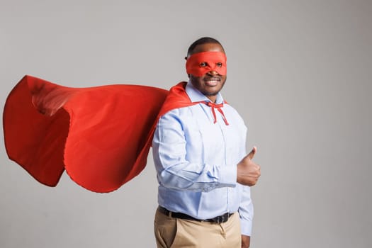 Confident Business Superhero Man in Cape and Mask Giving Thumbs Up,