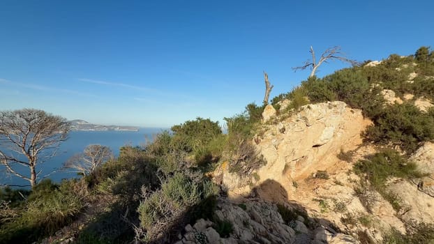 The breathtaking scenery showcases stunning rocky cliffs, vibrant lush foliage, and serene beautiful ocean vistas