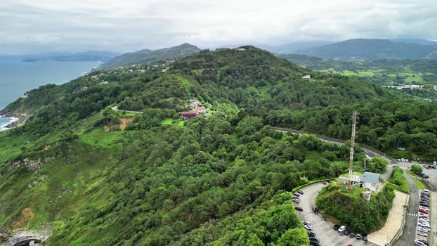 A stunning aerial perspective beautifully showcasing the breathtaking verdant hills meeting the serene coastline