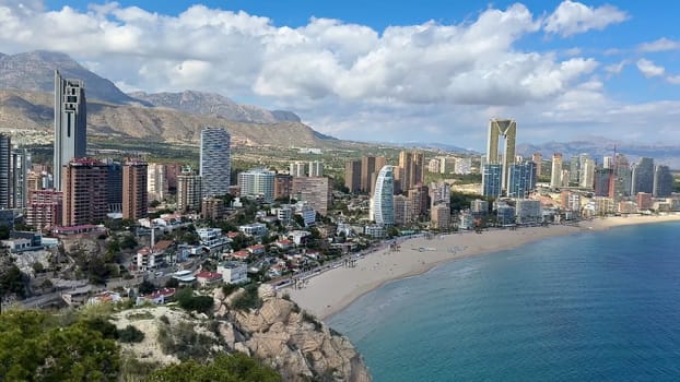 Enjoy the breathtaking aerial view of Benidorms impressive skyline with a beautiful beach in the foreground