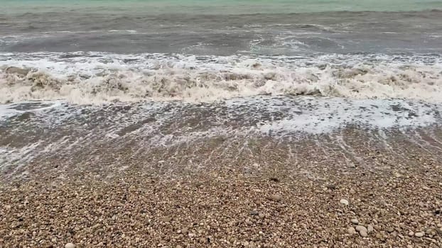 Gentle waves rhythmically crashing upon a lovely pebble beach, beautifully showcasing natures serene allure and charm
