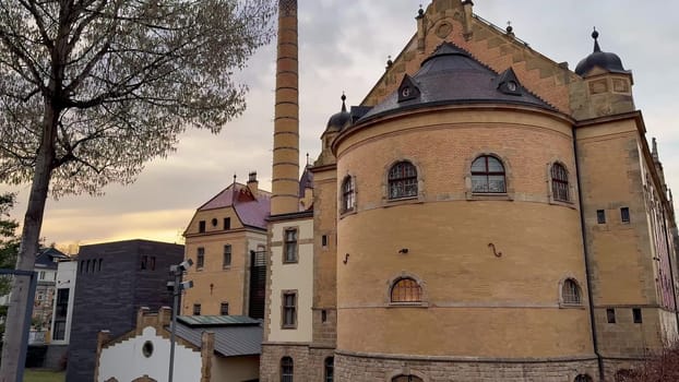 A captivating blend of historic and industrial architecture at sunset creates a stunning visual atmosphere