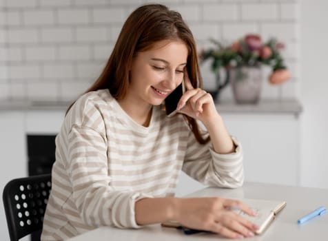 Girl Smiling While Talking On The Phone At Home