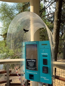 Moscow, Russia, April 23, 2025: Vending machine with bird food for personal feeding in Moscow Zoo. Buying food in Zoo with payment in cash and by bank card for saving and helping birds in public park