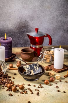 Marble cheese, coffee beans, macadamia nuts, brown sugar, cinnamon sticks, candles, and moka pot create a cozy atmosphere