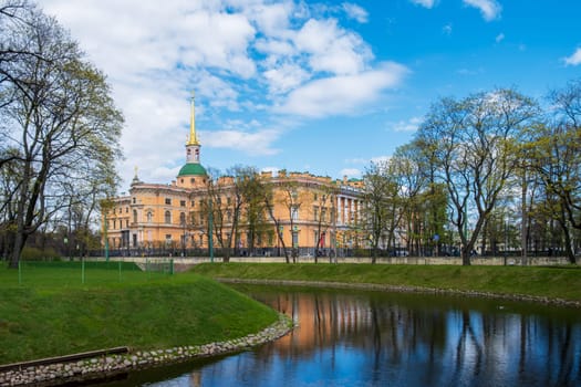 Saint Petersburg, Russia - 02.05.25. The historic Mikhailovsky Castle reflected in a canal surrounded by parkland