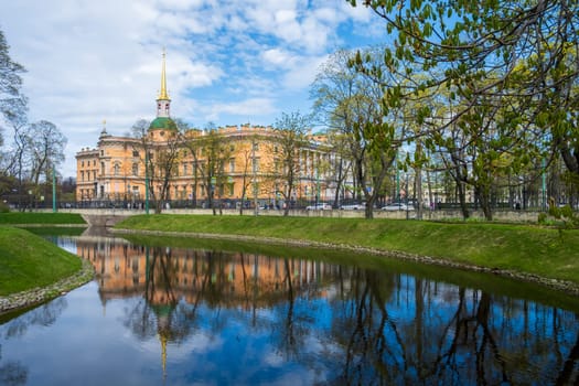 Saint Petersburg, Russia - 02.05.25. The historic Mikhailovsky Castle reflected in a canal surrounded by parkland