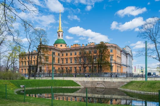 Saint Petersburg, Russia - 02.05.25. The historic Mikhailovsky Castle reflected in a canal surrounded by parkland