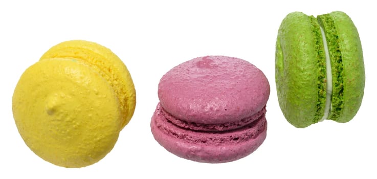 Three multicolored macarons with white filling on isolated background