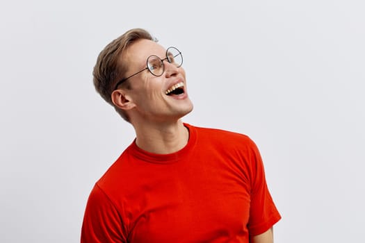 Happy middle-aged woman with short hair, round glasses, and vibrant red casual wear, expressing joy and laughter, standing against a plain white backdrop. Concept: positivity and well-being.