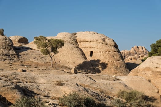 Burial caves in the Necropolis hills on walk from entrance to As Siq in Petra