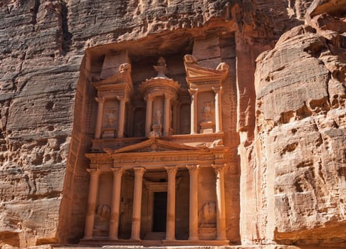 View of the carved facade of the Treasury building or Al-Khazneh in the ancient city of Petra