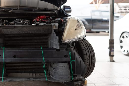 Denter or car mechanic serviceman check and fix body work and fiber bumper body part for fix and repair problem at car garage or repair shop