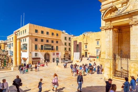 Valletta, Malta - April 2, 2025: A group of tourists walking on Pjazza Jean de Vallette