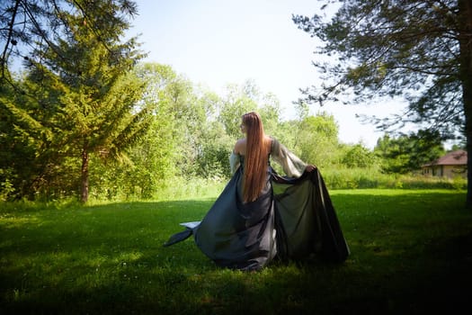 Beautiful dryad or fairy in nature. Pagan spirit of forest. Environmental friendliness, caring for nature. Adult mature woman 40-60 in Photo shoot