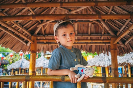 Portrait of a Caucasian schoolboy child boy on a playground in summer
