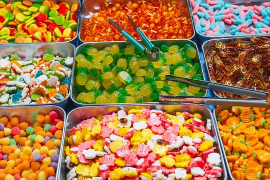 assortment of colorful marmalade and chewable candies on counter in the store