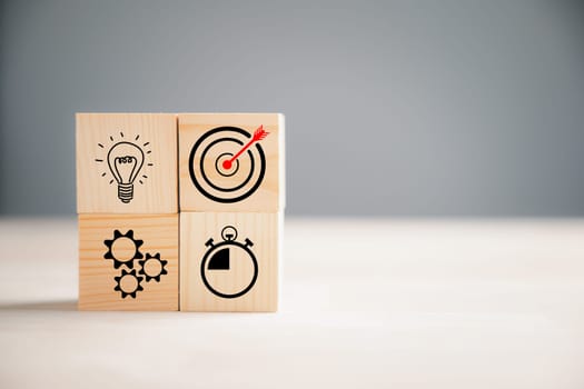 Wooden block step with Action Plan, Goal, and Target icons. Success and business target concept. Company strategy and project management on a table. Marketing background.