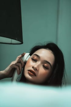 Young Woman on Phone at night in bedroom