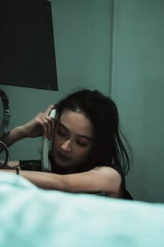 Young Woman on Phone at night in bedroom