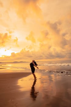 an Asian woman is enjoying the beauty of the beach and sea water in the late afternoon