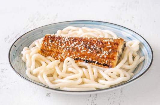 Thick udon noodles topped with glazed eel, richly coated in savory unagi sauce